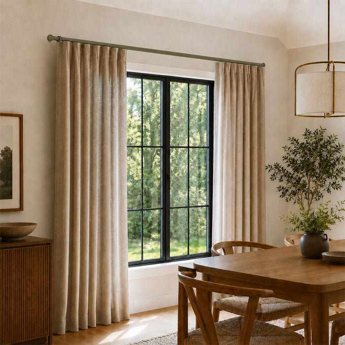 Ringo Curtain Rod Kit installed with beige curtains framing a large window in a minimalist dining room featuring wood furniture, soft natural light.