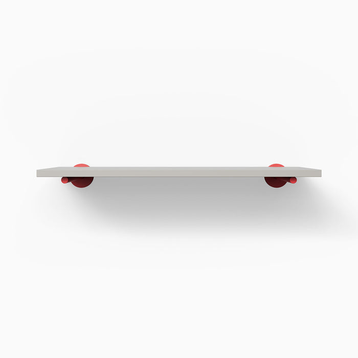Roderick Concretey Wall Shelf with smooth concrete surface and bold red metal floating shelf brackets for modern display