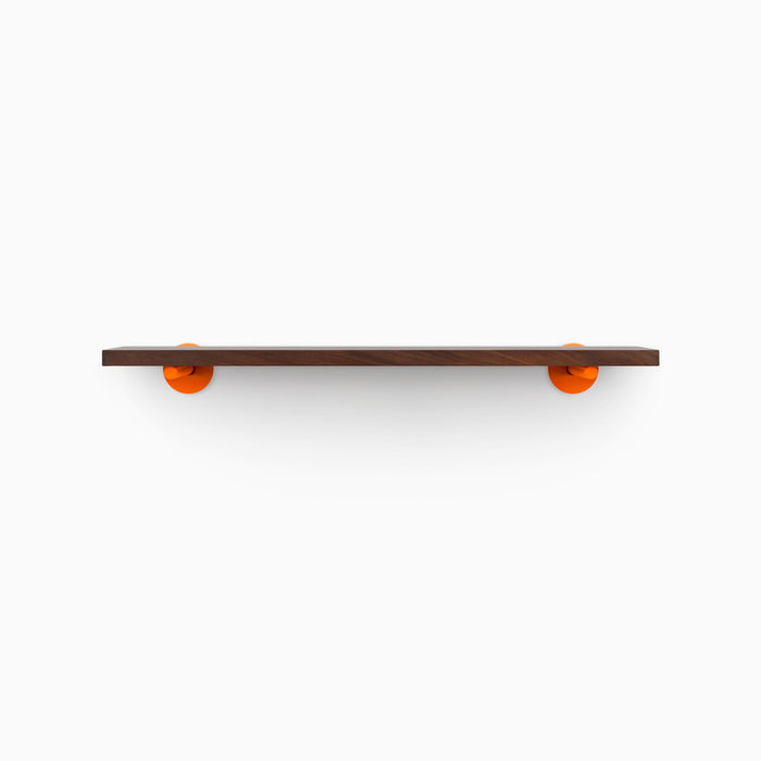 Roderick Dutch Mocha Wall Shelf with rich mocha hardwood and bold round orange metal floating shelf brackets for modern display