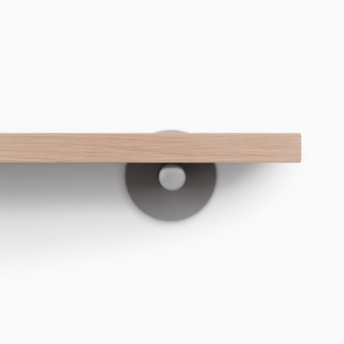 Roderick Glazed White Oak Wall Shelf with smooth hardwood and sleek round arsenic gray metal floating shelf bracket detail