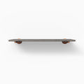 Roderick Hatch Grey Rustic Wall Shelf with textured grey hardwood and round copper metal floating shelf brackets for subtle display
