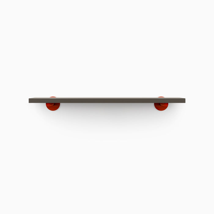 Roderick Tungsten Wall Shelf with smooth tungsten finish and bold red metal floating shelf brackets for striking wall display