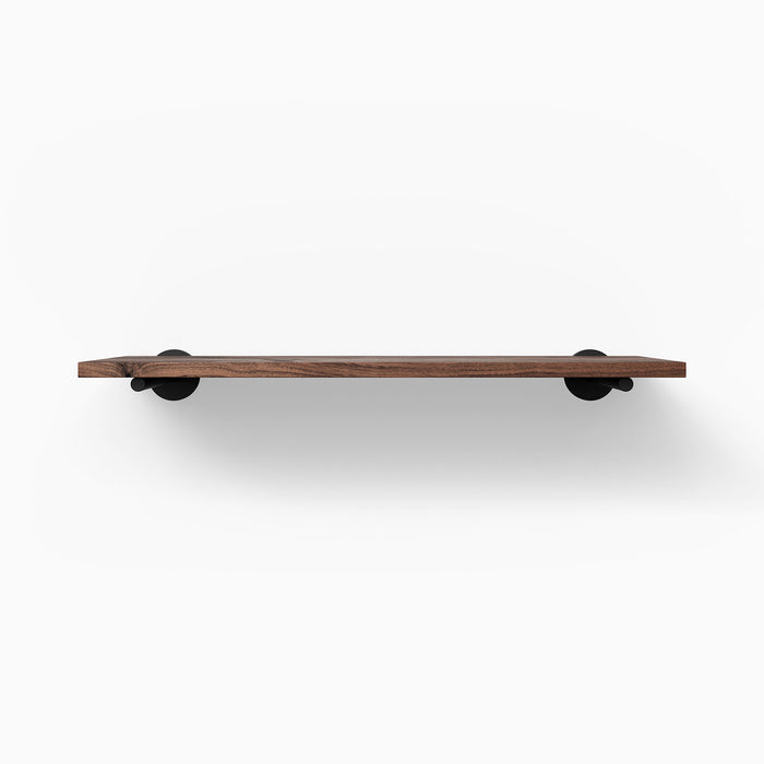 Roderick Walnut Wall Shelf with smooth walnut glue-up and black metal floating shelf brackets for sleek display and organization