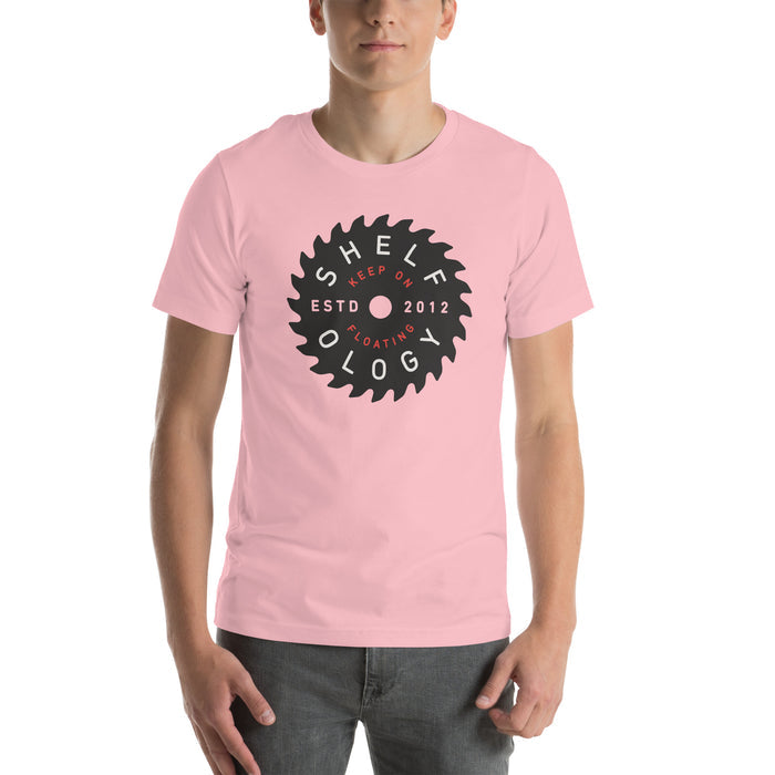 Rough Sawn T-shirt in soft pink with black circular saw blade logo and red "Keep on Floating" text, unisex fit by Shelfology