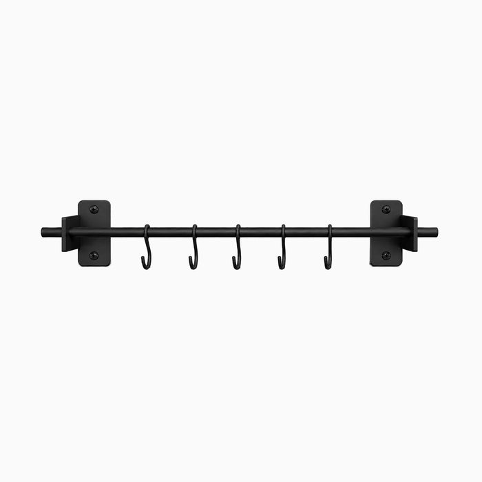 Rue Utensil Rack in black metal with six hooks for wall-mounted organization, designed for functional and minimalist kitchen storage.