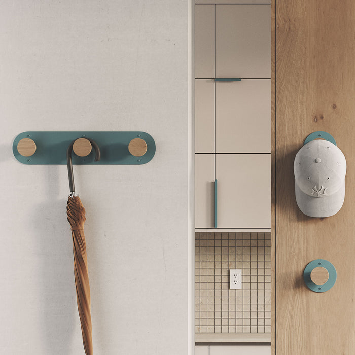 Runda Coat Rack 7 with solid hardwood pegs and muted blue steel base for organized wall display and storage