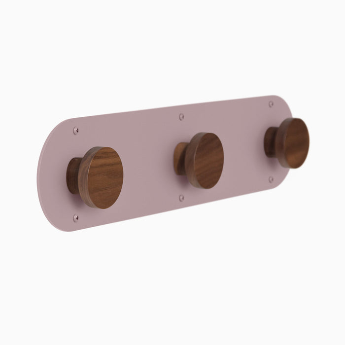 Runda wall hook with three solid walnut hooks and purple dusk steel backplate, shown in three-quarter view