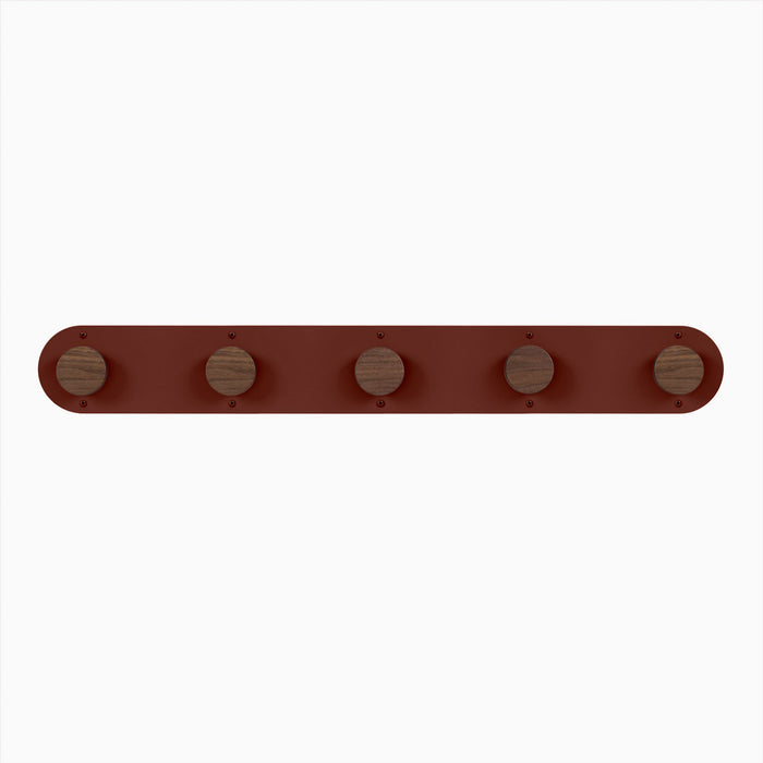 Runda Coat Rack 5 with five solid hardwood pegs on a rust-colored steel base for stylish wall hooks and organization