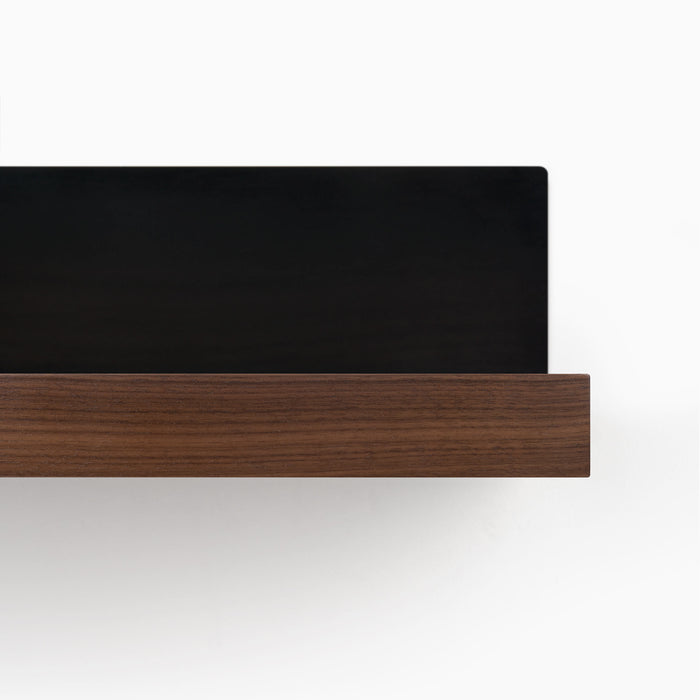 Skaksel Walnut Floating Shelf featuring a solid walnut ledge with a matte black steel mount for sleek wall display and organization