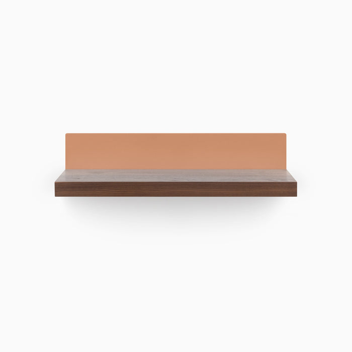 Skaksel Walnut Floating Shelf with a rich walnut ledge and a subtle clay-colored steel mount for sleek wall display.