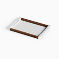 Slide Serving Tray combining smooth walnut hardwood side rails with a sleek white steel base and integrated handles for stylish serving and display.