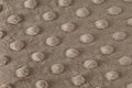 Close-up of a textured taupe fabric with raised dots