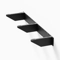 Sturdy black metal Steddy FM Floating Bench Bracket mounted on a white wall, designed for secure floating shelf support with a minimalist profile.
