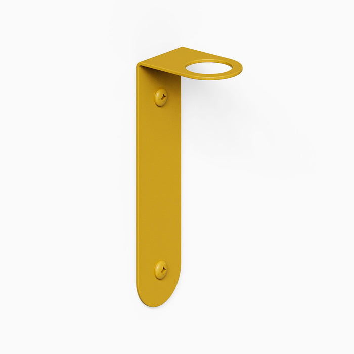 Minimalist yellow metal floating shelf bracket with two screw holes and a circular cutout, designed for wall mounting and display ledges.