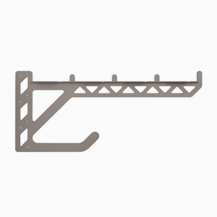Studly 2x6 Utility Bracket in dark steel with triangular cutouts and integrated hook for sturdy floating shelf hardware and wall display