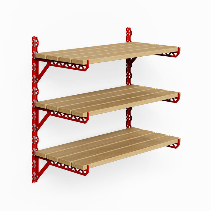 Studly Wall Storage System 2x6 Bracket featuring three solid hardwood floating shelves supported by bold red metal brackets for customizable wall organization and display