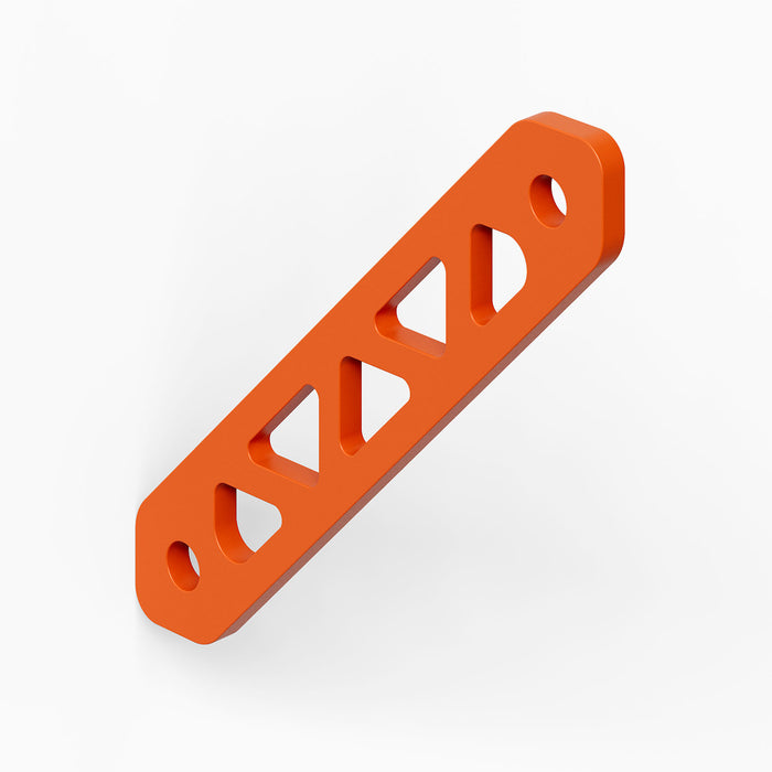 Studly Wall Storage System Steel Shelf Bracket in vibrant orange powder-coated steel, engineered for strong, minimalist support of floating display shelves.