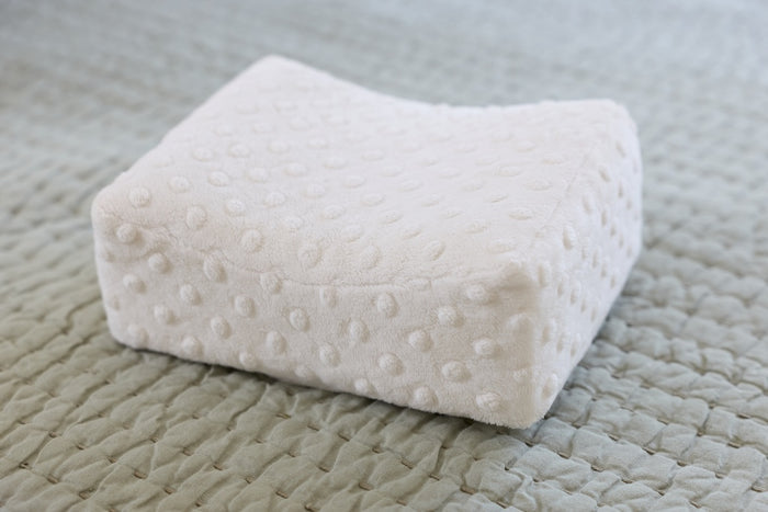White textured pillow on a textured surface