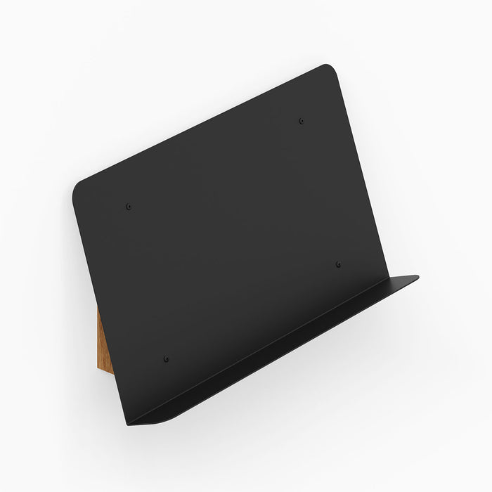 The Edit Book +Magazine Display wall-mounted with a sleek black metal front and solid hardwood back, perfect for minimalist organization and display.