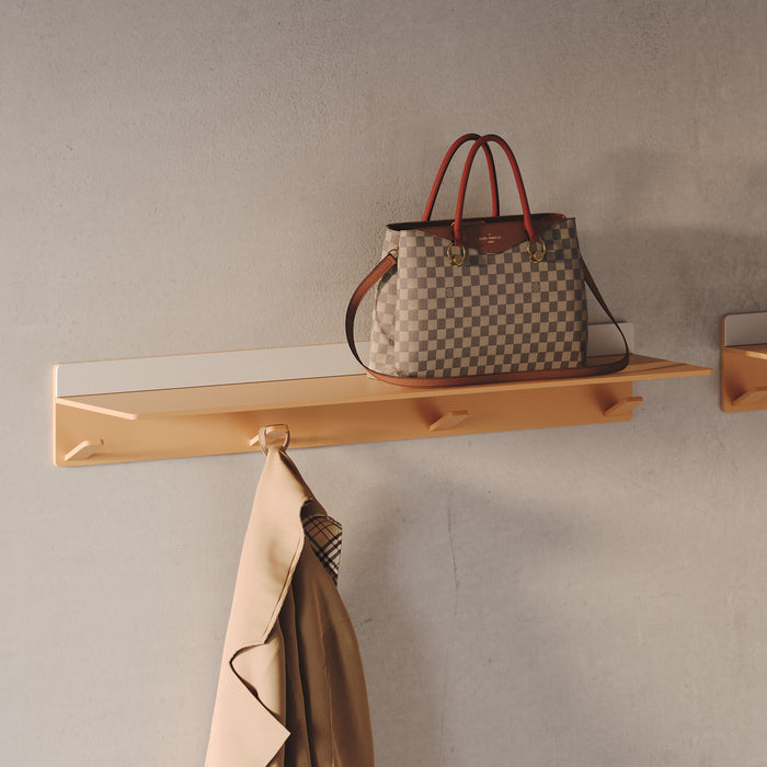 Tromso Steel Floating Shelf + Coat Rack in muted terracotta with integrated wall hooks holding coat and handbag by Shelfology