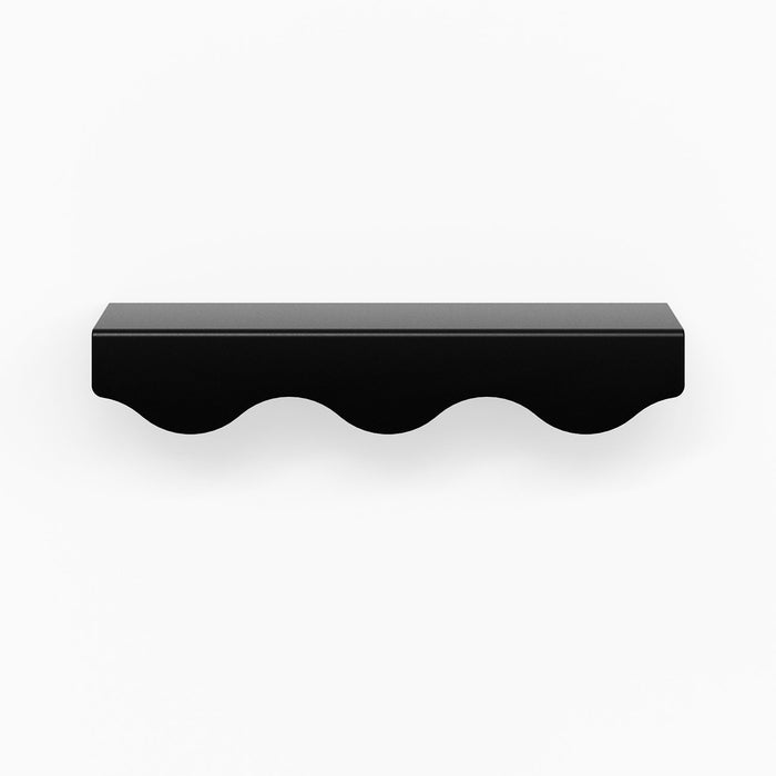 Wave Cabinet Pull in matte black with smooth flowing curves for durable, minimalist floating shelf hardware design