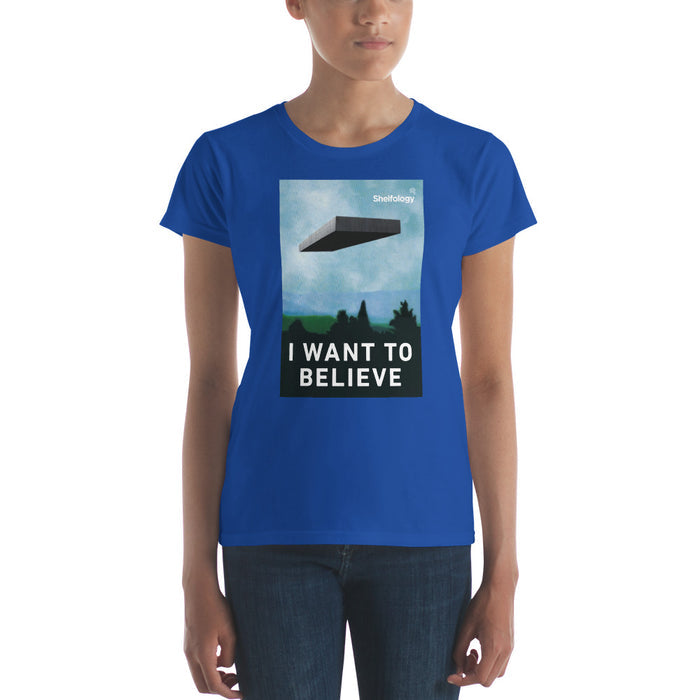 Women's Believe T-shirt in royal blue featuring a floating shelf graphic and "I WANT TO BELIEVE" text by Shelfology