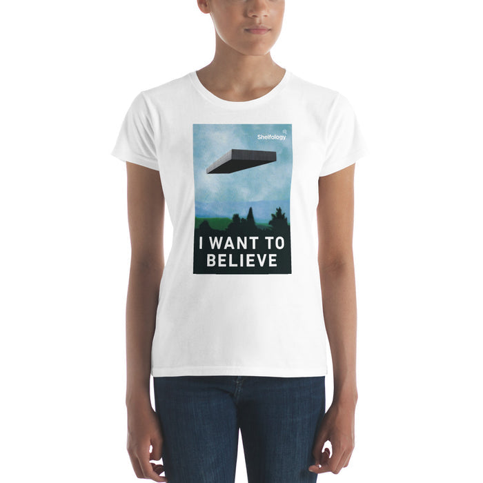 Women's Believe T-shirt in white featuring a graphic of a floating shelf and "I WANT TO BELIEVE" text by Shelfology
