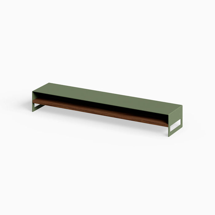Woz Monitor Stand featuring a minimalist design with an olive green metal frame and solid walnut wood shelf, perfect for organized workspace display.