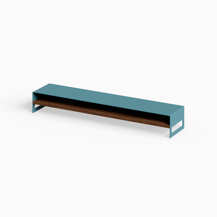 Woz Monitor Stand featuring a minimalist steel frame in muted teal with a solid hardwood walnut shelf for durable, stylish workspace organization.