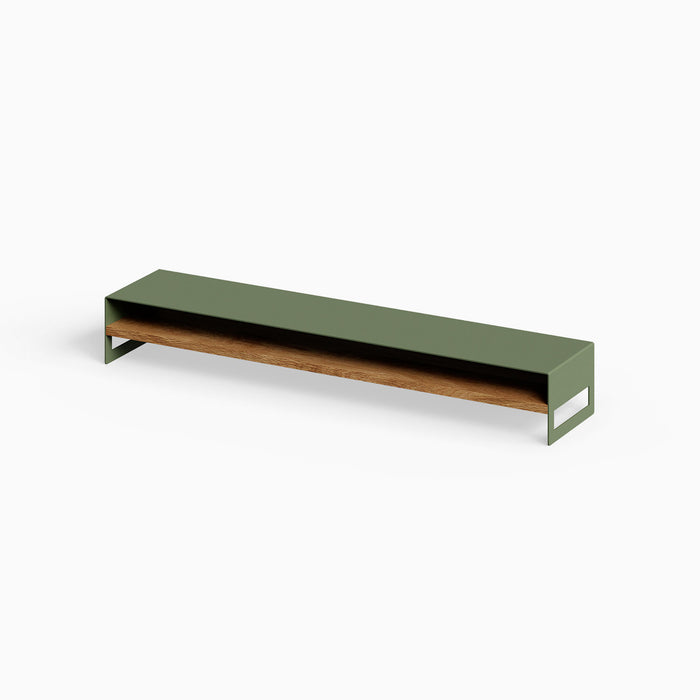 Woz Monitor Stand with minimalist olive green metal frame and solid hardwood shelf, designed to elevate and organize workspace essentials.