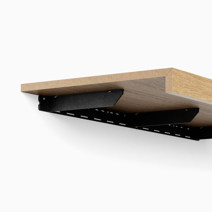 Yuri FM Floating Desk Bracket in matte black steel providing strong support for a wood floating desk installation